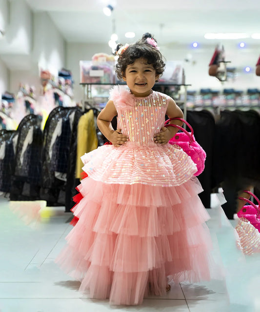 It’s peach Colored party wear gown that comes with the back zip closure. Moreover, it is paired up with short sleeves that can be stitched as per requirement. It features big flowers and comes with the fabric belt to be tied at the back.