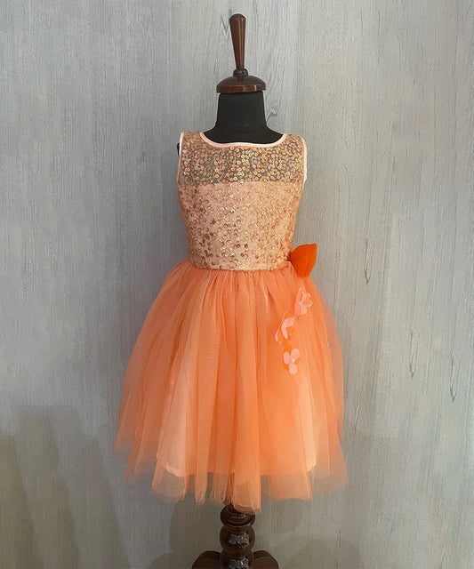 It’s a orange Colored frock that comes with a back zip closure. These kids party wear clothes are an amazing option to shop online. It features sequin and floral detailing on the dress.