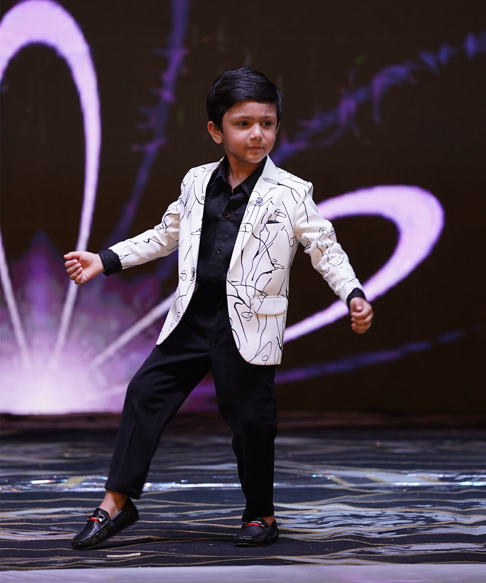 This boys wedding outfit consists of a self-printed Blazer and a matching self-printed black Colored t-shirt.