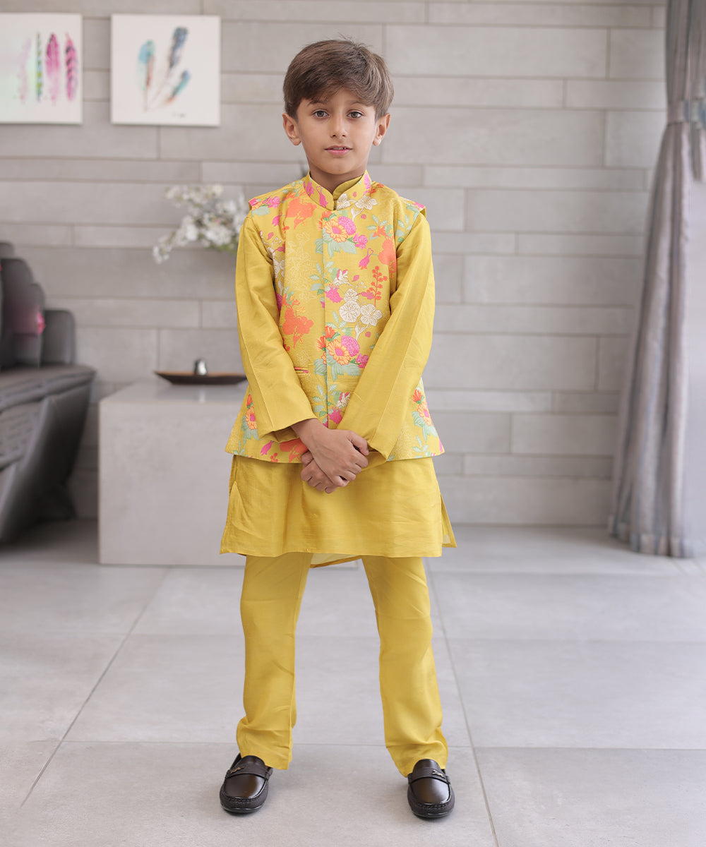  It is a mustard coloured kurta pyjama set that comes with a matching waistcoat, can be creatively styled with ethnic shoes and is the best boy's designer kurta-pyjama set.