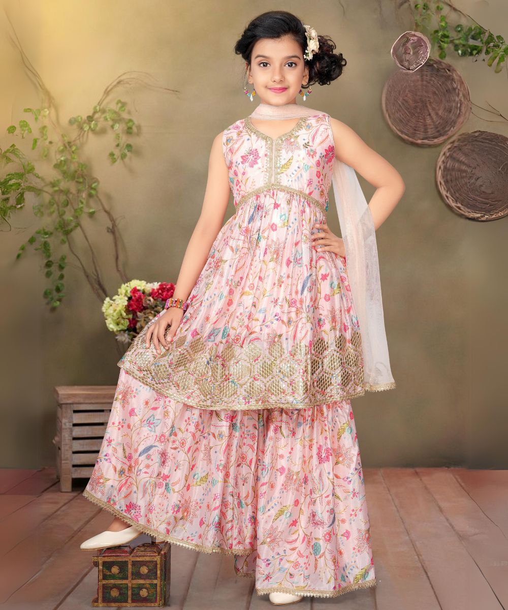 This baby girl pink colored sharara suit consists of a kurta with a back zip closure, a matching sharara and a dupatta.